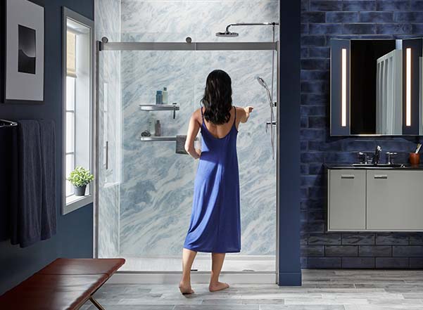 Woman entering shower with stone bluette walls
