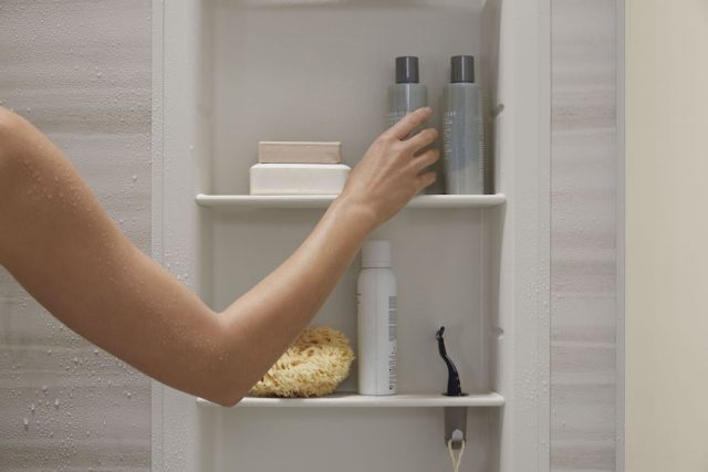 woman adjust shower products'