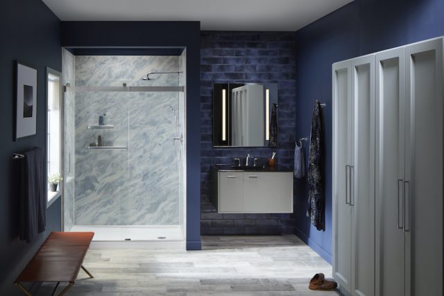 A bathroom with a Kohler LuxStone Shower that has blue and white colored Bluette shower walls