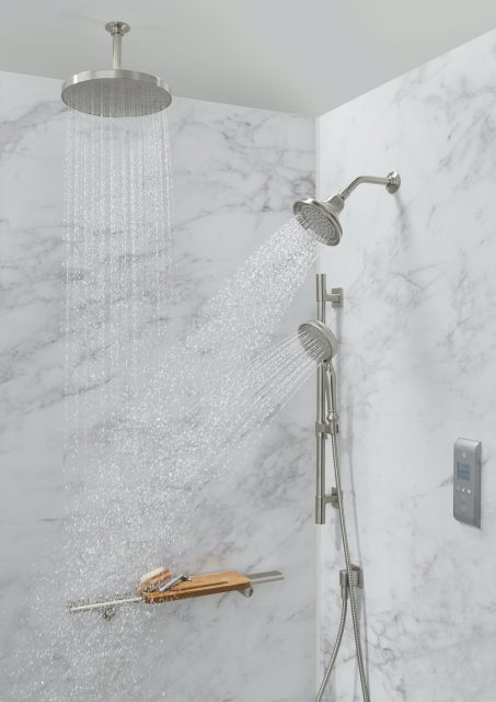 Calacatta shower walls featuring rainhead and handshower