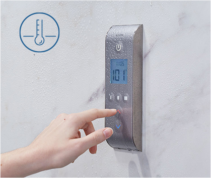 Hand pressing button on digital shower system remote.