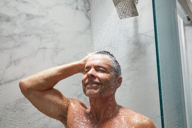 Man washing hair in shower'