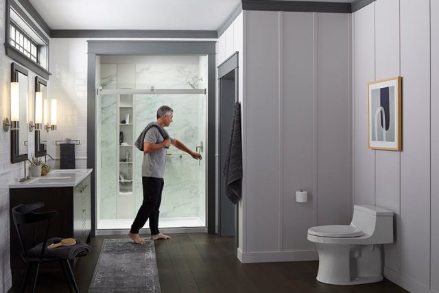 Man closing shower door'