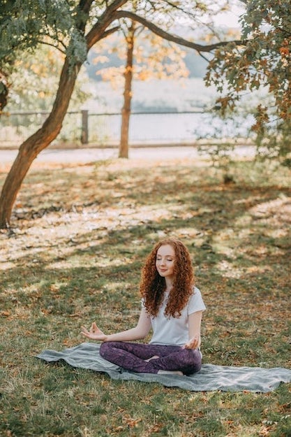 Woman meditating in park