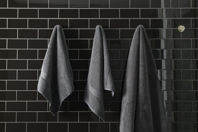 towels hanging on bathroom wall