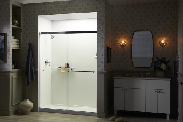 Bathroom at night with illuminated walk-in shower.'