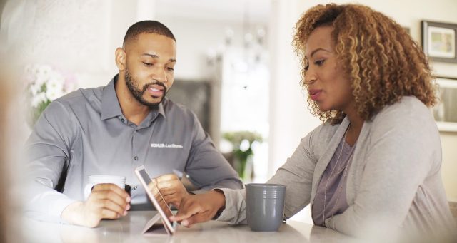 Photo of in-home quote and customer touching iPad