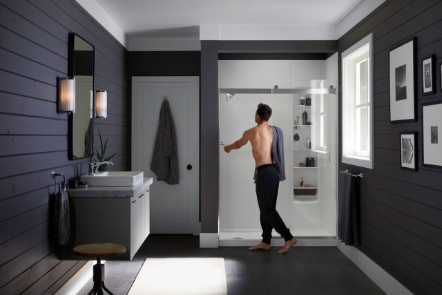 Man getting into his Kohler LuxStone shower'