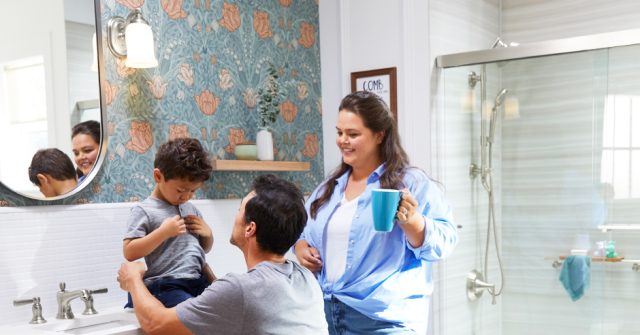 parents getting child ready in the bathroom'