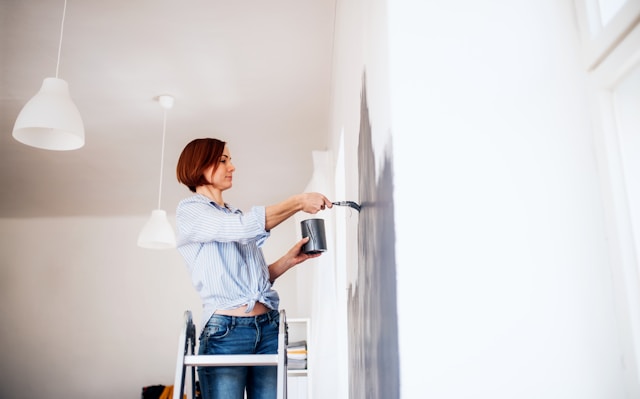 person painting wall 