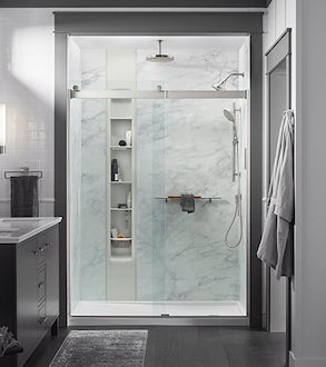 A modern bathroom with a Kohler LuxStone shower with multiple faucets