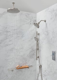 A Kohler LuxStone shower with overhead faucets and a DTV system
